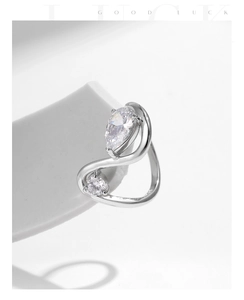Macro detail of silver irregular open ring with pear and round cut cubic zirconia stones