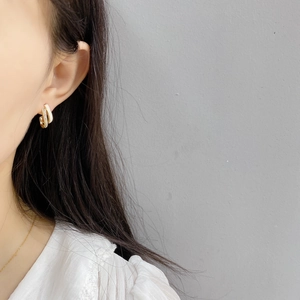 Double-layered gold earrings with crystals and white enamel finish for women