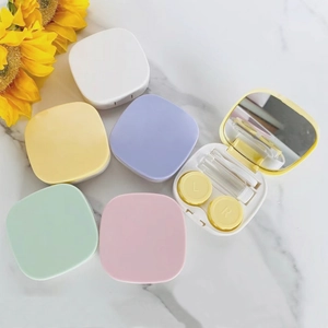 Portable oval contact lens case set with mirror, tweezers and solution bottle in pastel colors