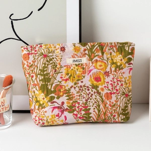 Detail of floral makeup bag with embossed flower pattern and JIMEIZI logo patch