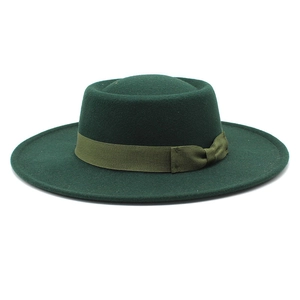 Close-up of dark green wool felt flat top hat with matching grosgrain ribbon bow