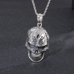 Detailed macro shot of skull pendant featuring half-polished and half-textured metal surface