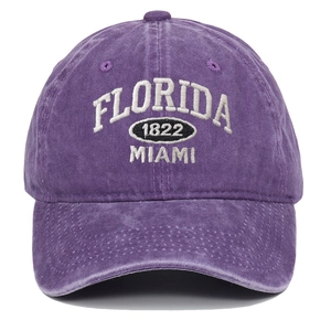 Close-up of white Florida 1822 embroidery on purple washed cotton baseball cap