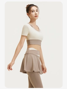 Detail of high-stretch color-block yoga set with breathable crop top and skirt shorts