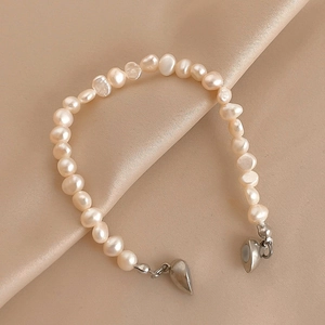 Bracelet élégant en perles naturelles avec fermoir magnétique coeur sur satin champagne