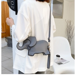 Cute grey elephant-shaped shoulder bag shown on model in a minimalist setting