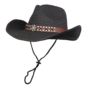 Detail of black straw cowboy hat featuring leather band with studs and vintage metal badge