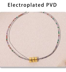 Macro detail of 316L gold necklace featuring colorful cubic zirconia and PVD plating