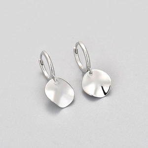 Polished silver irregular round disc dangle hoop earrings with a minimalist hammered texture