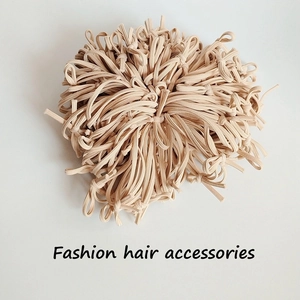 Detailed view of beige high-elasticity hair ties stacked in a large bulk pack