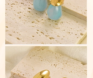 Macro detail of blue resin teardrop earrings with gold polished stainless steel clasps