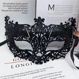 Detail of black glitter Venetian fox mask with intricate lace cutout patterns