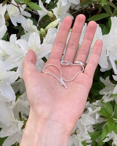 S925 sterling silver snake bone necklace with unique geometric OT buckle held in hand