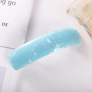 Close-up of a light blue marble-textured acetate hair clip with iridescent pearl finish