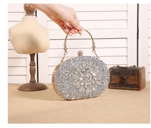 Detail of silver sunflower evening bag with sparkling rhinestones and gold ring handle