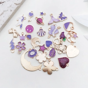 Detailed set of purple enamel gold pendants including stars, hearts, and shells for DIY