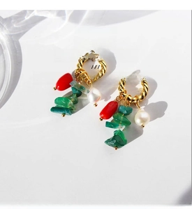 Detail of twisted gold earrings with red beads, green natural stone and baroque pearl