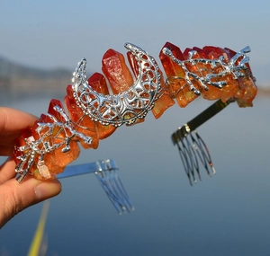 Detail of bohemian crown with orange crystal raw stones and silver moon metal accents