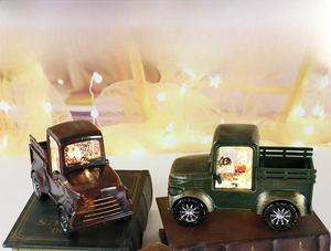 Retro Christmas pickup truck lantern with Santa Claus figurine and warm festive lighting