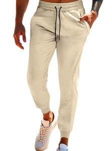 Detail of men's slim joggers featuring an adjustable drawstring waist and ribbed cuffs