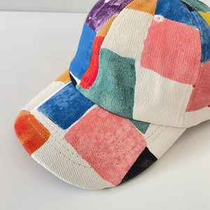 Close-up of a colorful patchwork baseball cap showing high-quality corduroy texture