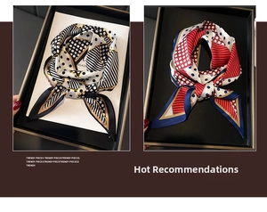 Detail of double-layer polka dot and striped silk scarves in elegant display tray