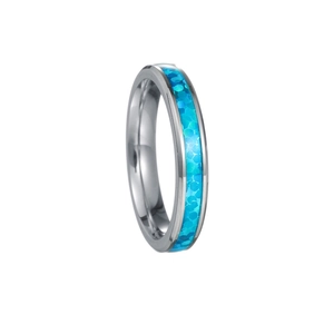 Close-up of silver titanium steel ring with sparkling blue opal-style inlay detail