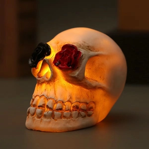 Halloween skull LED lamp with ivory resin finish and decorative red and black roses
