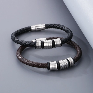 Close-up of black and brown braided leather bracelets with polished silver magnetic clasps