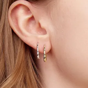 Elegant crescent star earrings in gold and silver, worn as stylish S925 silver hoop studs