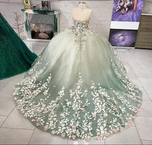 Detail of 3D floral appliqués on mint green gradient tulle ball gown with sequins