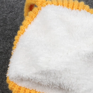 Close-up of yellow knit fabric and soft white plush lining on the beer mug hat