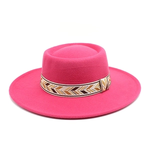 Detail of fuchsia wool felt hat with bohemian fishbone woven band on flat wide brim