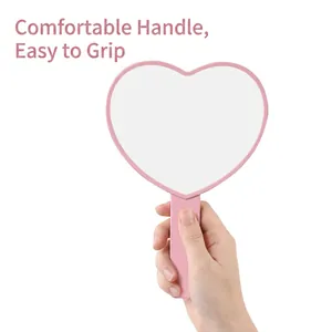 Minimalist pink heart-shaped handheld makeup mirror with comfortable grip handle