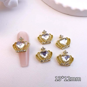 Detail view of 13x12mm golden crown nail art charms with crystal heart inlay