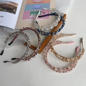 Detailed view of the intricate hand-woven crystal beads and pearls on the metal headband