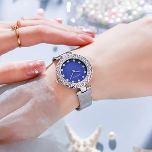 Elegant ladies quartz watch with blue shell dial and silver mesh strap on wrist
