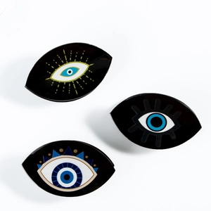 Three minimalist black Evil Eye hair claws with blue and yellow artistic designs
