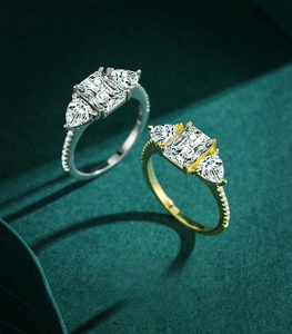 Macro shot of gold and silver S925 sterling silver three-stone rings with pavé diamonds