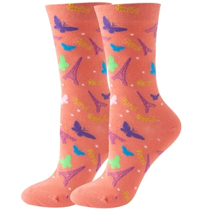 Detail of pink crew socks featuring butterfly patterns and Eiffel Tower motifs