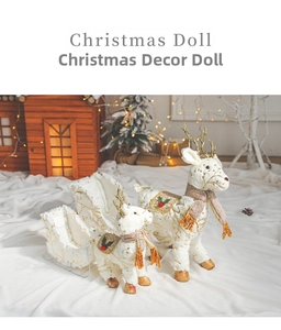 Close-up of white plush Christmas reindeer with gold patterns and matching sleigh decor
