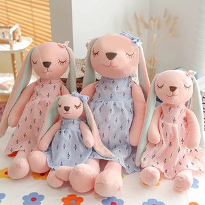 Four plush long-eared rabbits in pink and blue floral dresses for home decoration