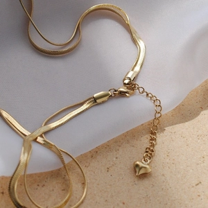 Minimalist double layer gold snake chain necklace featuring a small heart pendant