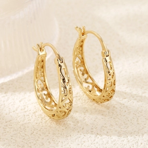 Vintage gold hollow oval hoop earrings with brushed texture and elegant geometric design
