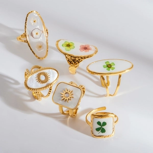 Gold stainless steel rings with resin flower and clover designs in various shapes