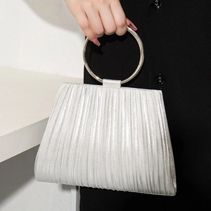 Silver pleated evening clutch bag with circular metal handle and elegant textured finish