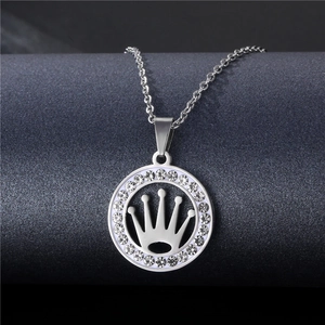 Macro shot of silver stainless steel pendant with crown design and sparkling stones