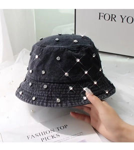 Close-up of denim bucket hat featuring shimmering rhinestones and washed black fabric
