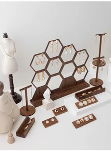 Walnut wood honeycomb jewelry display stand with golden pearl earrings and necklaces