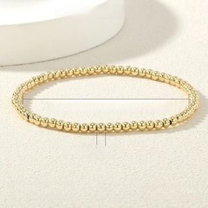 Macro detail of a 3mm 18K gold-plated stretch bead bracelet with 16-17cm inner perimeter